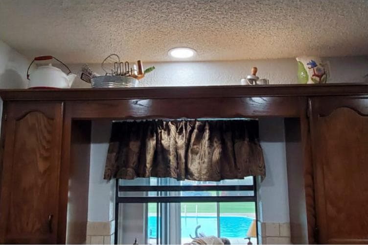 After — bright, modern recessed LED light installed above the kitchen window by M Electric
