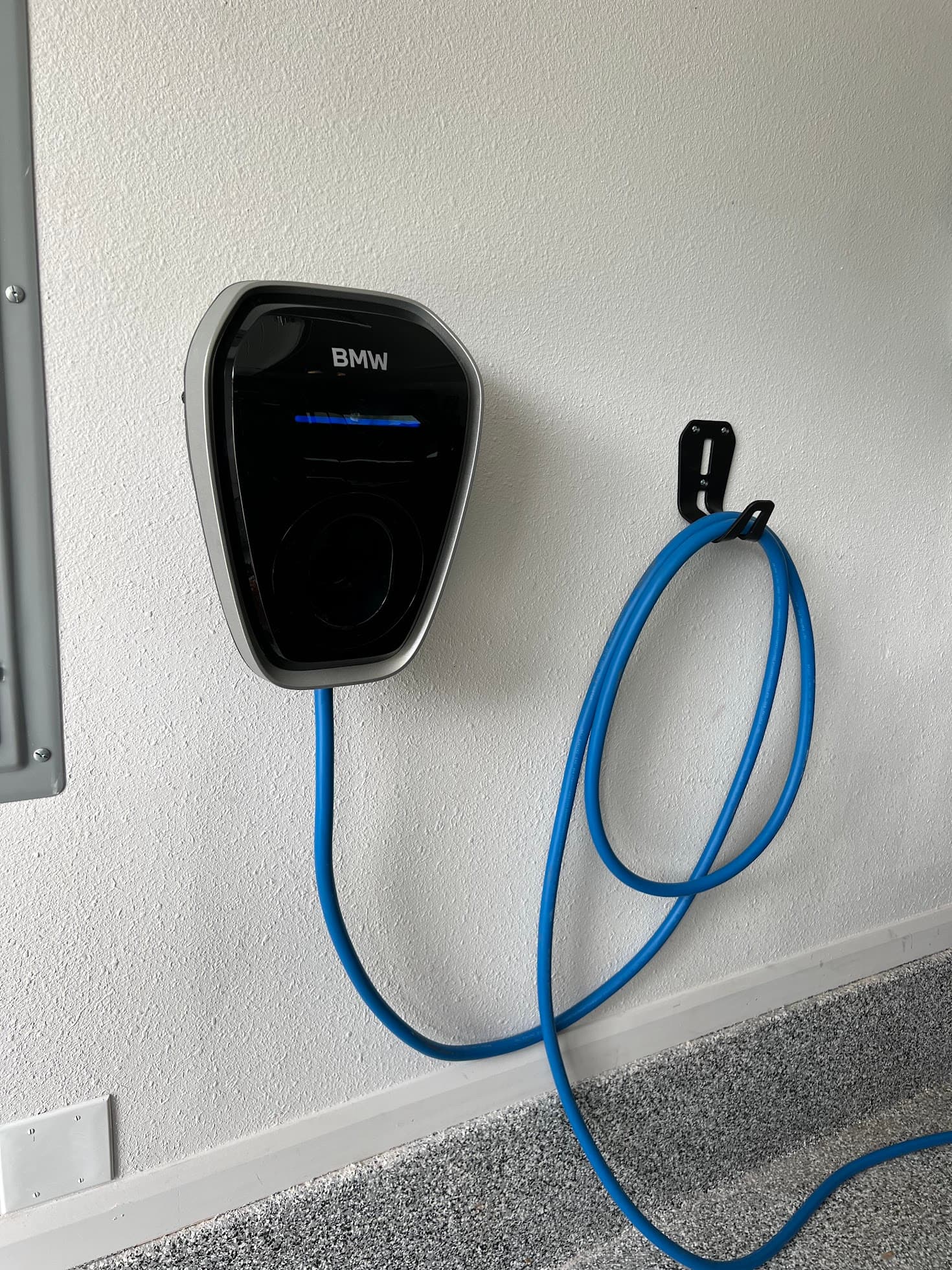 Wall-mounted Level 2 EV charger installed by M Electric at a Tulsa-area home — a real install, real wiring, professionally mounted